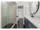 Updated bathroom with patterned shower tile and marble vanity at 10069 E Turquoise Ave, Scottsdale, AZ 85258