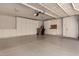 Spacious garage with ample storage cabinets and overhead door at 10069 E Turquoise Ave, Scottsdale, AZ 85258