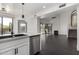 Modern kitchen island with a farmhouse sink, stainless steel dishwasher and open view to Gathering room at 10069 E Turquoise Ave, Scottsdale, AZ 85258