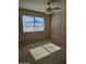 Spacious bedroom with large window and ceiling fan at 10546 W Catalina Dr, Arizona City, AZ 85123