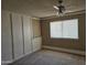 Bright bedroom with wall paneling and carpeted flooring at 10546 W Catalina Dr, Arizona City, AZ 85123