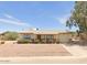 Ranch style home with a carport and well-manicured front yard at 10546 W Catalina Dr, Arizona City, AZ 85123