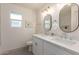 Updated bathroom with double vanity, marble tile, and modern fixtures at 1164 E Westchester Dr, Tempe, AZ 85283