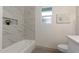 Clean bathroom with a bathtub, marble tile, and updated fixtures at 1164 E Westchester Dr, Tempe, AZ 85283