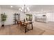 Modern dining area with a stylish wood table, chandelier, and adjacent kitchen at 1164 E Westchester Dr, Tempe, AZ 85283