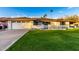 Ranch style home with a white brick facade, attached garage, and well-manicured lawn at 1164 E Westchester Dr, Tempe, AZ 85283