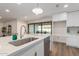 Modern kitchen island with a quartz countertop, stainless steel sink, and dishwasher at 1164 E Westchester Dr, Tempe, AZ 85283