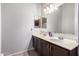 Double sink bathroom with dark wood cabinets and a large mirror at 1269 N Layman St, Gilbert, AZ 85233