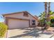 Light tan home with two-car garage and mature landscaping at 1269 N Layman St, Gilbert, AZ 85233