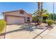 Tan two-car garage with attractive landscaping at 1269 N Layman St, Gilbert, AZ 85233