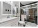 Modern bathroom with white vanity, large mirror, and walk-in shower at 13635 N 111Th Ave, Sun City, AZ 85351