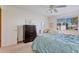 Bright bedroom with queen bed, dresser, and additional seating at 13635 N 111Th Ave, Sun City, AZ 85351