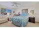 Comfortable bedroom with a queen bed, ceiling fan, and ample closet space at 13635 N 111Th Ave, Sun City, AZ 85351