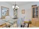 Light and airy dining room featuring a glass table and wooden hutch at 13635 N 111Th Ave, Sun City, AZ 85351