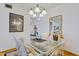 Bright dining room with glass table, chandelier, and built-in hutch at 13635 N 111Th Ave, Sun City, AZ 85351