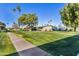 Pathway through a grassy area with building in background at 13635 N 111Th Ave, Sun City, AZ 85351