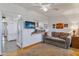 Living room with a brown couch and view of the kitchen at 13635 N 111Th Ave, Sun City, AZ 85351