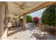 Covered patio with seating area and desert landscaping at 14215 W Mountain Laurel Trl, Surprise, AZ 85374