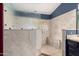 Large walk-in shower with marble tile and built-in seat at 14215 W Mountain Laurel Trl, Surprise, AZ 85374