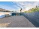 Gravel backyard with a gate and a tall block wall at 14241 N 54Th St, Scottsdale, AZ 85254