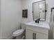 Clean and modern powder room with white vanity and black accents at 14241 N 54Th St, Scottsdale, AZ 85254