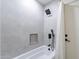 Modern bathroom with gray tile, black fixtures, and a shower/tub combo at 14241 N 54Th St, Scottsdale, AZ 85254