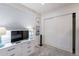 Bedroom with white dresser, TV, and sliding closet doors at 14241 N 54Th St, Scottsdale, AZ 85254