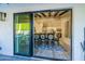 View through sliding glass doors showing a formal dining room with a large table and chairs at 14241 N 54Th St, Scottsdale, AZ 85254