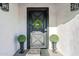 Elegant front door with a stylish metal design and lush greenery at 14241 N 54Th St, Scottsdale, AZ 85254