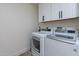 Functional laundry room with washer, dryer and storage cabinets at 14241 N 54Th St, Scottsdale, AZ 85254