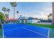 Blue paddle ball court with a net and a house in the background at 14241 N 54Th St, Scottsdale, AZ 85254