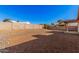 Large backyard with gravel, block wall, and covered patio at 14352 W Lamoille Dr, Surprise, AZ 85374