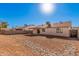 Backyard view of house, showing a gravel yard and a covered patio at 14352 W Lamoille Dr, Surprise, AZ 85374