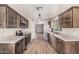 Modern kitchen with dark wood cabinets, granite countertops and stainless steel appliances at 14352 W Lamoille Dr, Surprise, AZ 85374