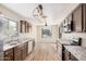 Modern kitchen with dark wood cabinets and stainless steel appliances at 14352 W Lamoille Dr, Surprise, AZ 85374