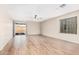 Spacious living room with wood-look tile floors and sliding glass door at 14352 W Lamoille Dr, Surprise, AZ 85374