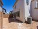Backyard showcases ample space, white stucco walls, and an external air conditioning unit at 14644 W Sand Hills Rd, Surprise, AZ 85387
