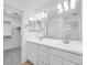 Bathroom showcasing a double sink vanity with modern fixtures, complemented by an adjacent walk-in closet at 14644 W Sand Hills Rd, Surprise, AZ 85387