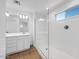 Bathroom featuring double sinks and a sleek glass-enclosed walk-in shower with refined fixtures at 14644 W Sand Hills Rd, Surprise, AZ 85387