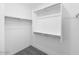 Walk-in closet with multiple levels of shelving and hanging rods at 14644 W Sand Hills Rd, Surprise, AZ 85387