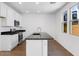 Modern kitchen featuring stainless steel appliances, granite countertops, and white cabinets at 14644 W Sand Hills Rd, Surprise, AZ 85387