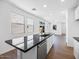 Kitchen island featuring a breakfast bar and stainless steel dishwasher at 14644 W Sand Hills Rd, Surprise, AZ 85387