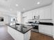 Open kitchen with white cabinets, granite countertops, stainless appliances, and a spacious island at 14644 W Sand Hills Rd, Surprise, AZ 85387
