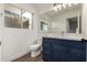 Modern bathroom with navy vanity and updated fixtures at 1506 E Topeka Dr, Phoenix, AZ 85024