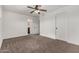 Bedroom with ceiling fan, carpeting, and access to bathroom at 1506 E Topeka Dr, Phoenix, AZ 85024