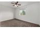 Bright bedroom featuring ceiling fan and neutral carpeting at 1506 E Topeka Dr, Phoenix, AZ 85024