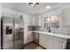 Modern kitchen with white cabinets, stainless steel appliances, and quartz countertops at 1506 E Topeka Dr, Phoenix, AZ 85024