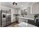 Modern kitchen with white cabinets, stainless steel appliances, and quartz countertops at 1506 E Topeka Dr, Phoenix, AZ 85024