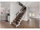 Stylish staircase with dark metal railing and carpeted steps at 1506 E Topeka Dr, Phoenix, AZ 85024