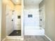 Modern bathroom with a large walk-in shower, separate bathtub, and marble tile at 15235 S Country Club Dr, Arizona City, AZ 85123